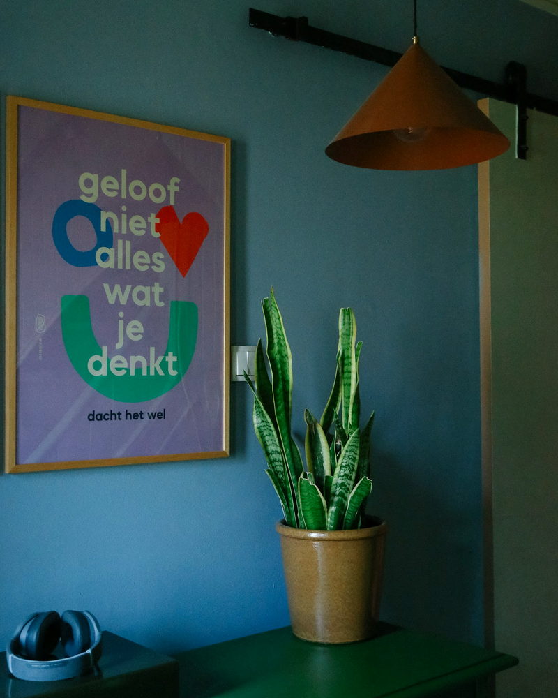Blue wall with poster and pendant light