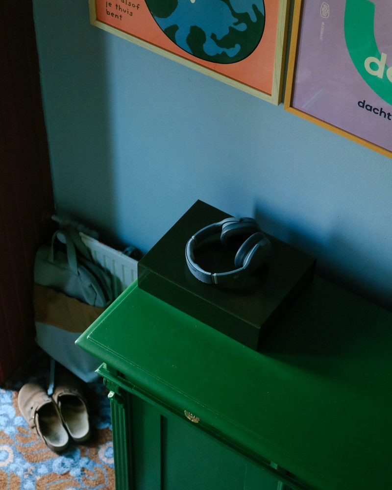 Green painted small cabinet in the hallway